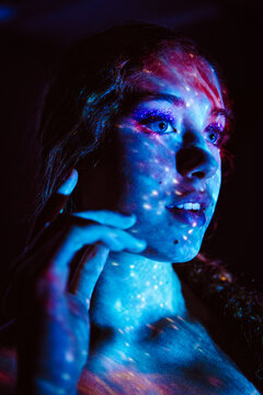 Portrait of a face illuminated by cosmic led projector light