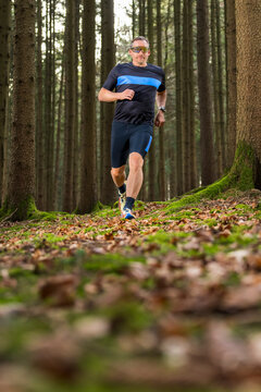 Athlete running on forest trail during endurance training
