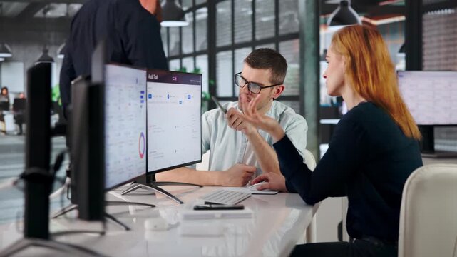 Auditor Carefully Reviews Activity Logs On Multiple Screens