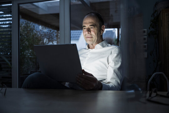 Freelancer having video call through laptop at home office