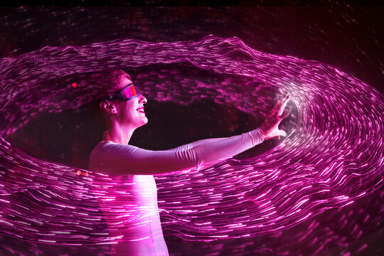 User with AR glasses interacting with glowing pink digital data
