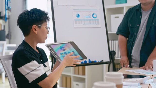 Young Asian colleagues teamwork in modern office space Discussing market trends and conducting data analysis to develop a successful business strategy together