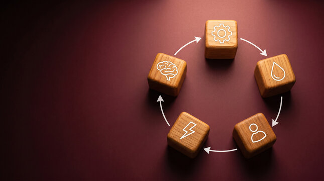 Five wooden cubes arranged in a pentagon with interconnecting feedback loop arrows on a warm burgundy background for systems thinking concepts.