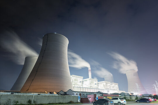 Nighttime View of Cooling Towers at a Coal-Fired Power Plant with Steam Plumes