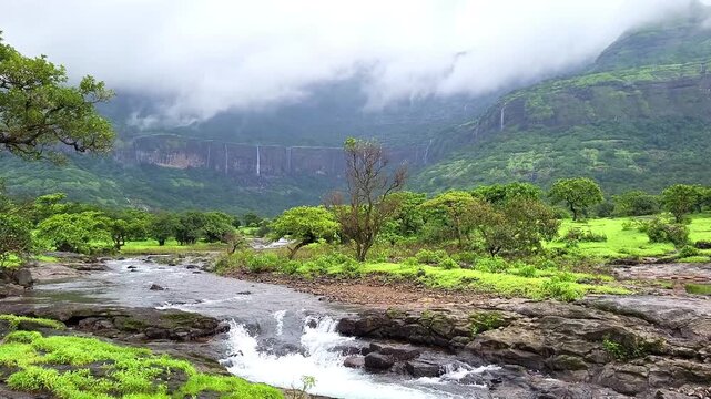 Hiwala Waterfall cascades beautifully behind mighty Kulang Fort, surrounded by misty cliffs and lush green Sahyadri valleys. A breathtaking 4K monsoon scene of raw nature and grandeur.