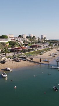 Alvor riverside marina and beach in Algarve, Portugal. Vertical aerial fly-over