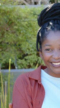 Couple smiling as camera panning right, cropping faces and revealing garden for marketing