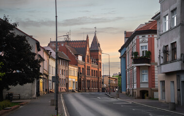 Obraz premium Street scene with local buildings, trees and roadway in Wałcz, West Pomeranian Voivodeship, Poland.