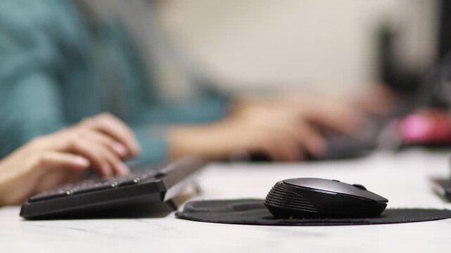 businesswoman typing on keyboard with blur background