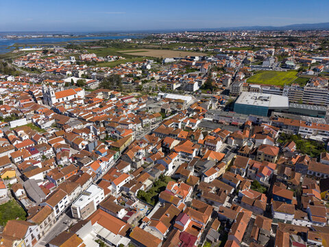 Aerial view of the town with its terracotta rooftops contrasting against the bright blue sky, Vila do Conde, Portugal.