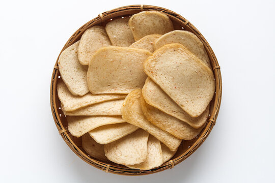 Top view of a basket of raw and uncooked prawn or shrimp crackers.