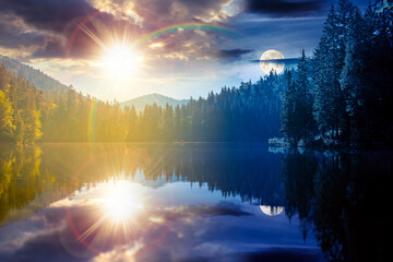 Fototapeta premium day meet night on quiet lake. sun and moon over coniferous forest reflecting on the calm body of water. epic place in national park. summer nature background image for astrology wallpaper concept