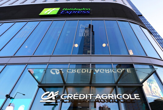 Warsaw, Poland, Europe - 04.2026 : Warsaw Hub complex, elliptical hotel building with Crowne Plaza and 5 star Holiday Inn Express, Credit Agricole Bank branch, complex was sold to Google in 2022