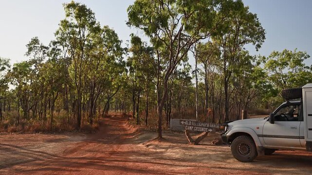 Off road vehicle parked at Old Telegraph Track sign near Bramwell Junction, Cape York, Queensland, Australia. Iconic 4WD route, remote adventure travel in rugged outback terrain.