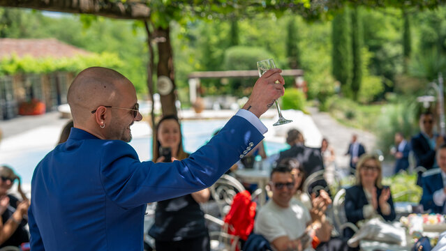 Celebrating friendship and happiness as the groom toasts with his friends at the wedding