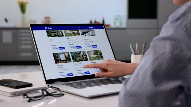 Young Woman Searching For Hotel Discounts Online Using Laptop