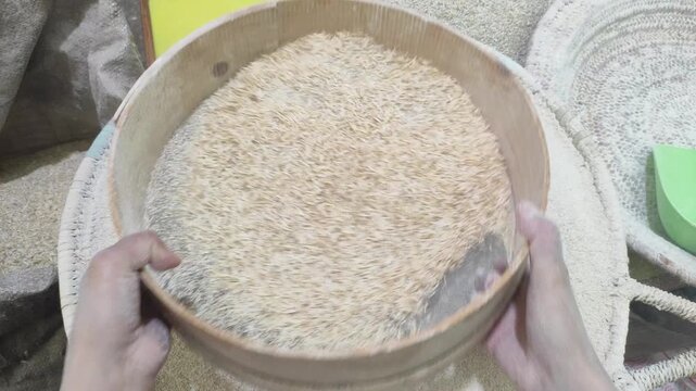 The art of homemade bread baking as a woman expertly sifts flour, a crucial step in creating delicious loaves, right in her own domestic kitchen.Morocco