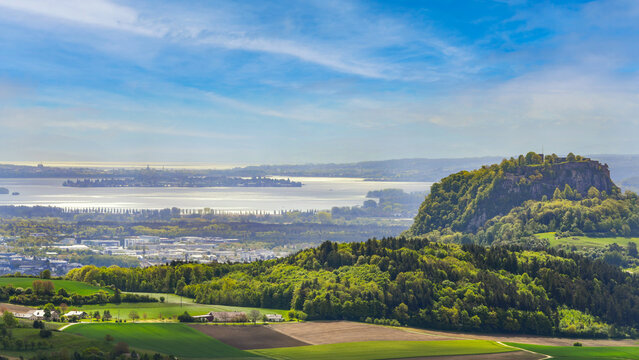 Panoramic landscape view of the Hegau volcanic mountain Hohentwiel in southern Germany, overlooking Lake Constance (Bodensee) with the island of Reichenau visible in the background. 