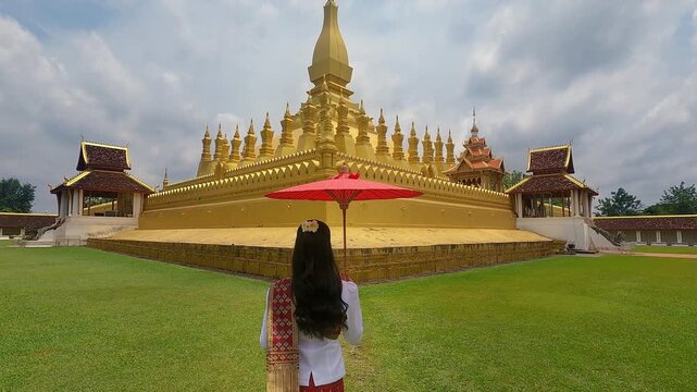 Asian woman wearing laos traditional at Phra that luang in Vientiane, Laos.