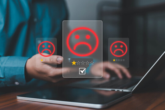 Customer feedback concept with negative rating on digital interface, sad emoticon and low star review on tablet and laptop, user experience dissatisfaction, online review system, quality evaluation