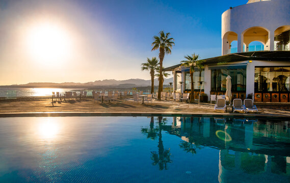 Sunset over the pool overlooking the sea
