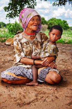 portrait of an Elderly San Woman with Young Children in Rural Botswana