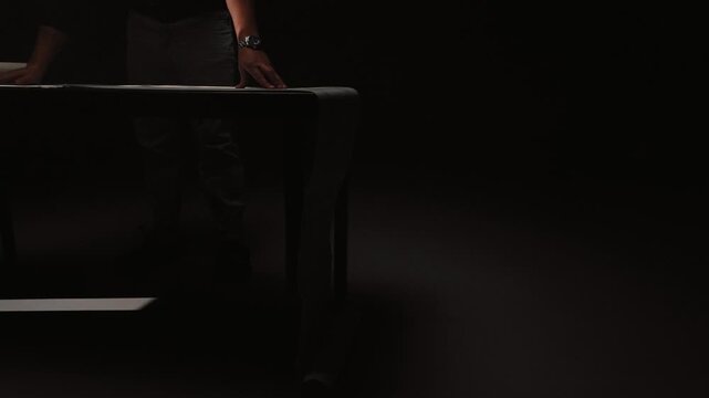 Large paper roll unrolling across table in cinematic lighting