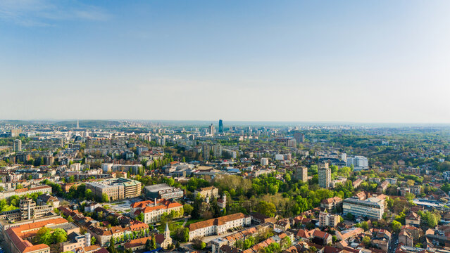Aerial view of the historic Zemun district with its red-roofed houses and lush green trees under a clear blue sky in Belgrade, City of Belgrade, Serbia.