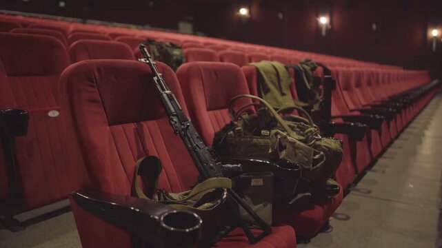 Rifles and Tactical Gear in Empty Cinema Hall: War's Impact on Kharkiv