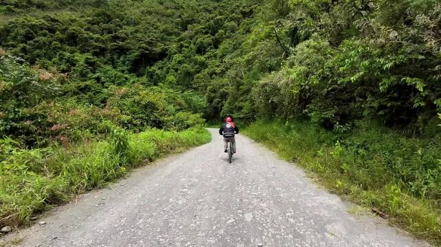 Mountain Biker Descending the North Yungas Road (Death Road), Bolivia