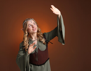 Naklejka premium Beautiful elf girl on brown gradient background, space for text