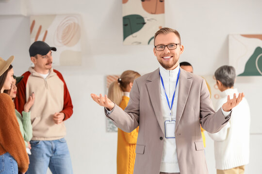 Male guide at exhibition in art gallery