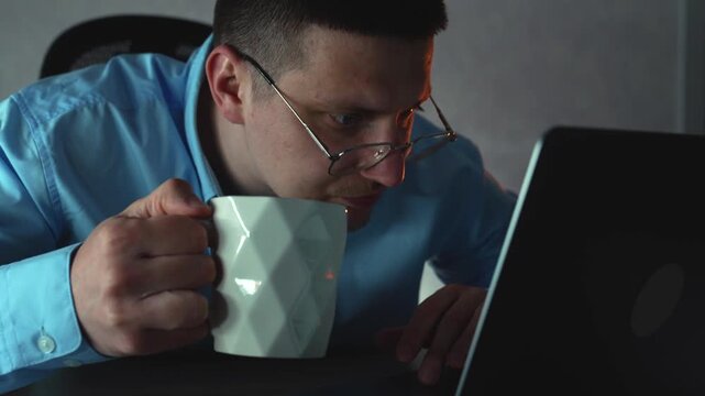 Man working overtime on a laptop to complete a client project before submission, balancing fatigue with focus. Idea of commitment and deadline-driven workflow.