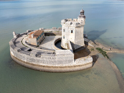 Aerial view of Fort Louvois standing firm amidst the shimmering waters, its stone walls reflecting the sunlight, Bourcefranc-le-Chapus, France.