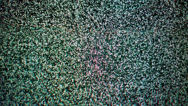 A chaotic pattern of black and white pixelated static flickers rapidly across the screen. Concept of technical difficulty, lost signal, retro technology, and communication failure.