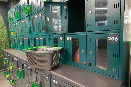 Lockers in a gym area with a basket placed on the shelf during a busy day in the city