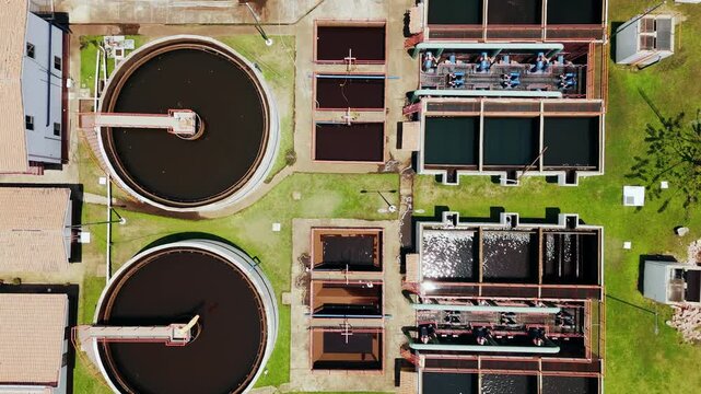 Aerial view of a water treatment plant with circular sedimentation tanks and rectangular filtration basins in Puerto Vallarta, Jalisco, Mexico.