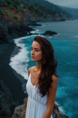 Obraz premium Woman gazing thoughtfully on rocky coastal cliff over ocean