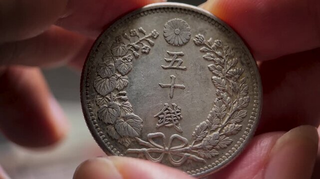 Macro Video of Physical Inspection of Meiji 50 Sen Silver Coin
