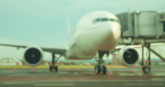Blurred view of unrecognizable large wide body jet preparing for international flight in Airport