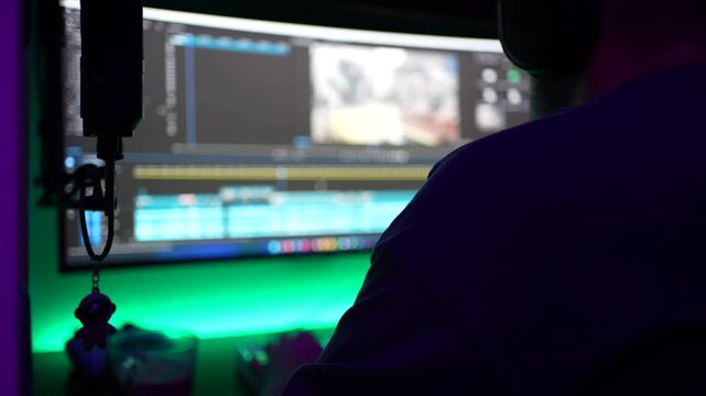 Video Editor Working at Night with Professional Editing Software