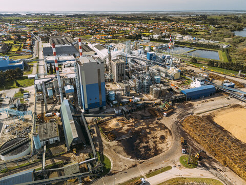 Aerial view of sprawling industrial complex juxtaposes sharp angles against the soft, verdant landscape meeting the skyline, Cacia, Portugal.