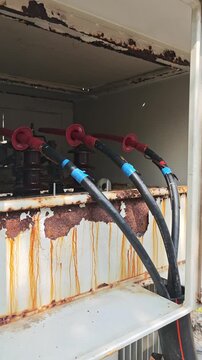 Close up of high voltage underground cable termination connected to industrial power transformer.