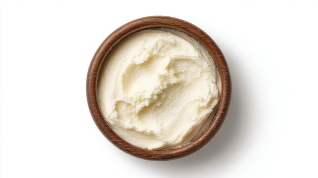 Bowl of creamy shea butter isolated on white background