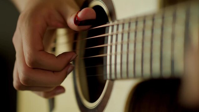 close up man playing guitar
