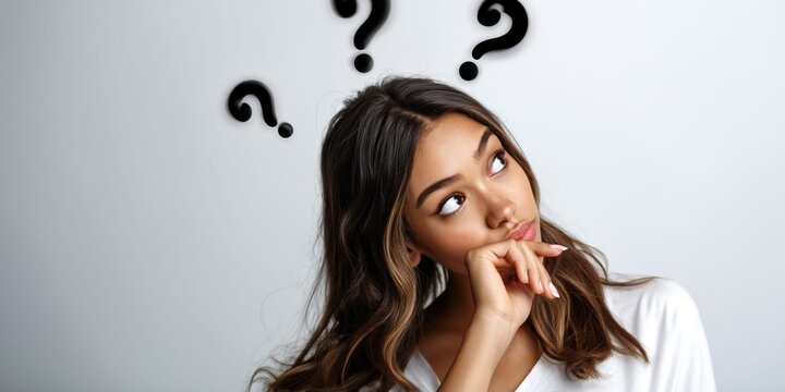 Young woman with question marks above her head pondering a difficult decision