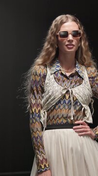 Fashion week, woman and walk with sunglasses on runway for clothes showcase, retro or vintage style. Catwalk show, model and couture wardrobe on stage for designer collection, brand design and event