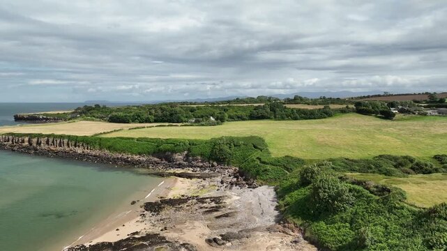 Aerial View of Rocky Coastline and Sandy Cove at Lligwy Beach Anglesey Wales