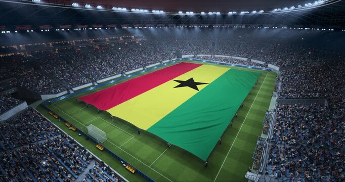 Professional Stadium With Soccer Game Championship With Flag of Ghana Spread Across Pitch Before Football Match Start. Cheering Crowds of Fans at Arena Anthem Ceremony. Aerial Static Wide Shot