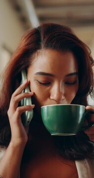 Woman, smile and phone call with coffee cup in office, hallway and contact at media company. Person, happy and mobile communication with consulting, drink or insight with talk at creative agency